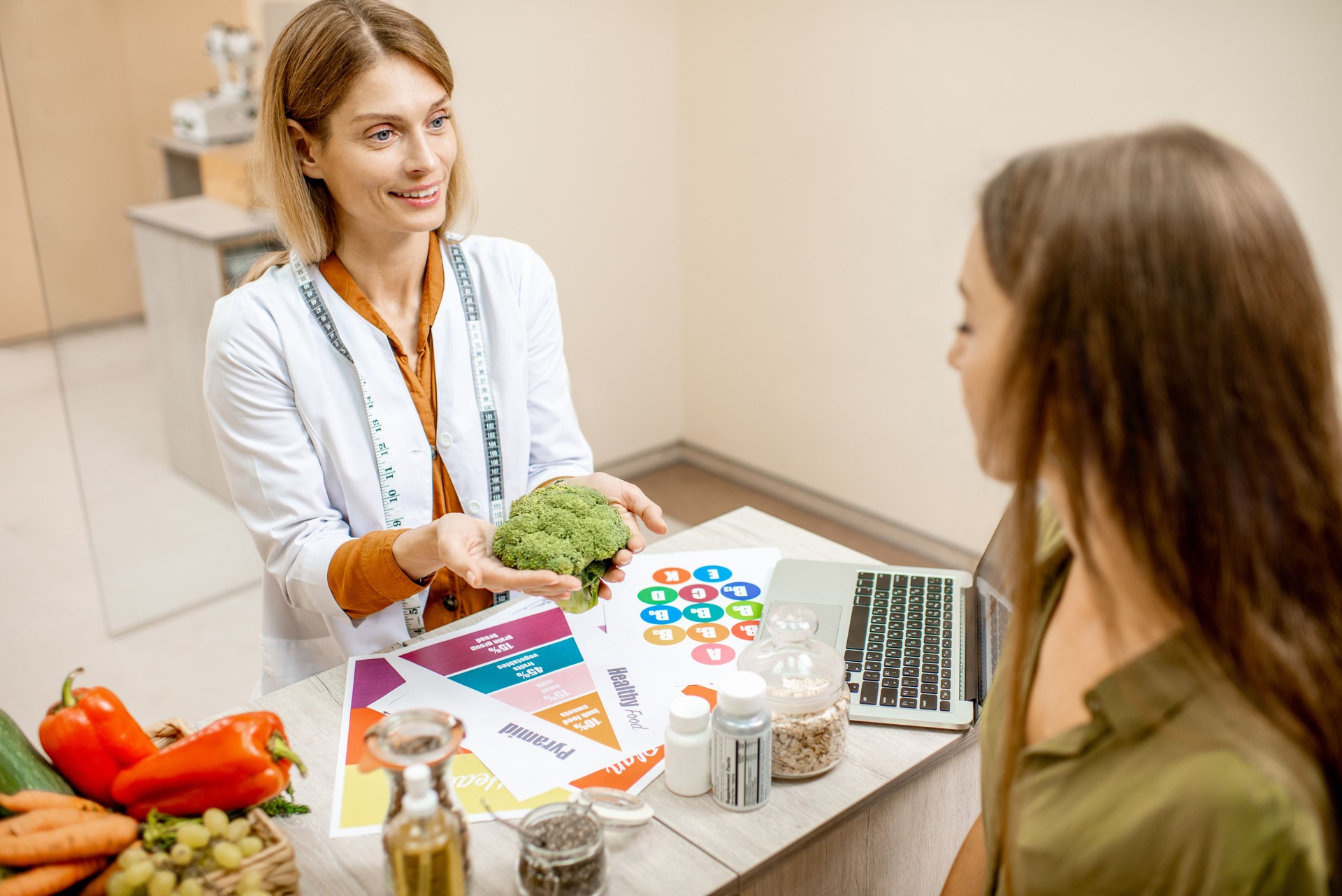 Nutritionist with female client at the office
